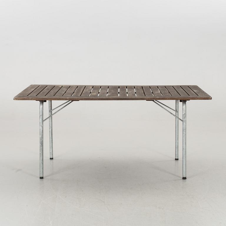 A GARDEN TABLE AND FOUR ARMCHAIRS FORM GRYTHYTTAN.