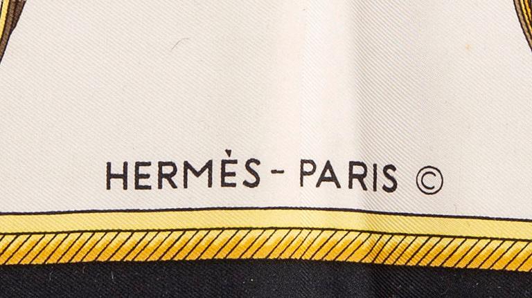 A set of two Hermès silk scarfs.  "Les Voitures a Transformation" och "Les Bècanes".