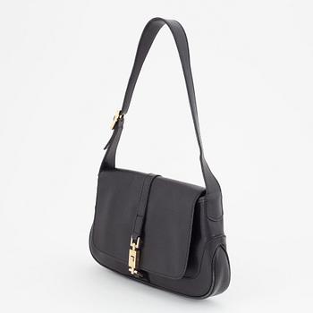 Gucci, a black and gold bag.