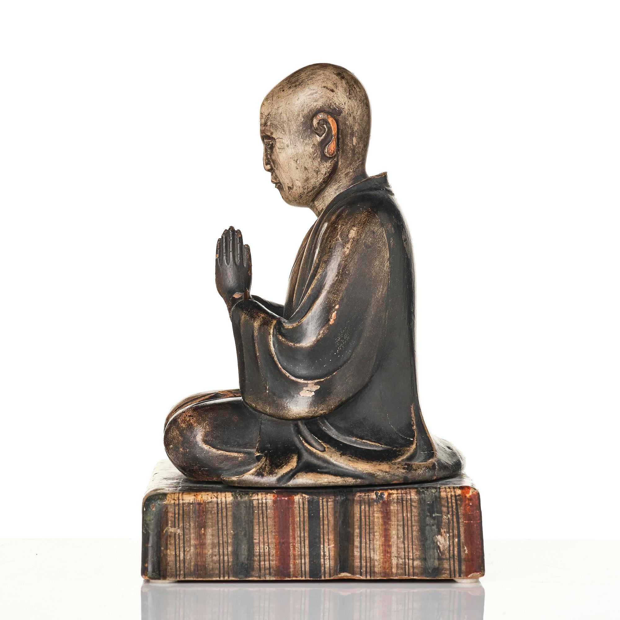 A painted and lacquered wooden sculpture of a monk, Japan, 19th century.