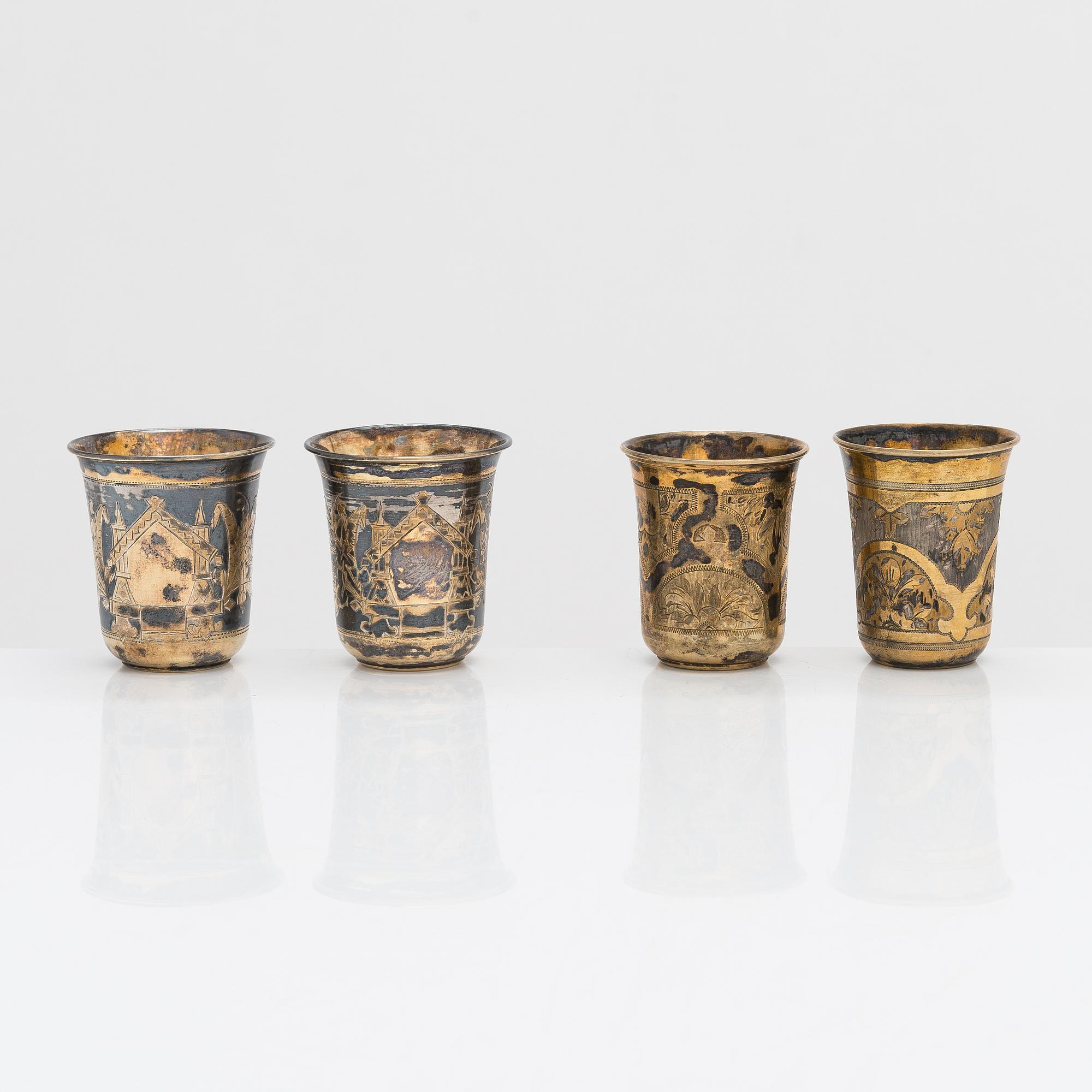 Four parcel-gilt silver beakers, Moscow 1870, 1876 and 1890.