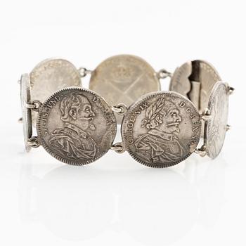 Two bracelets, a brooch, and a pendant with coins.