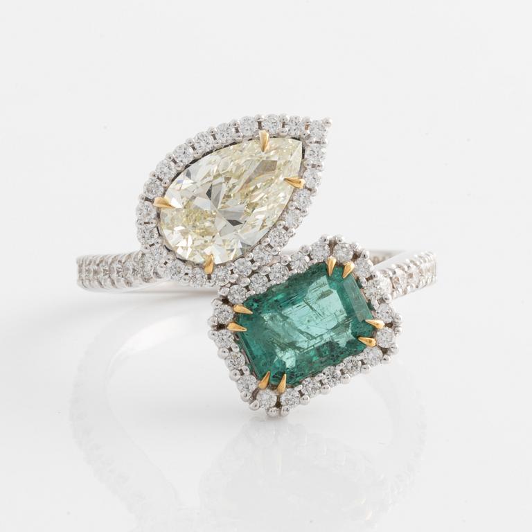 Ring with emerald-cut emerald and pear-shaped diamond, accompanying GIA diamond report.