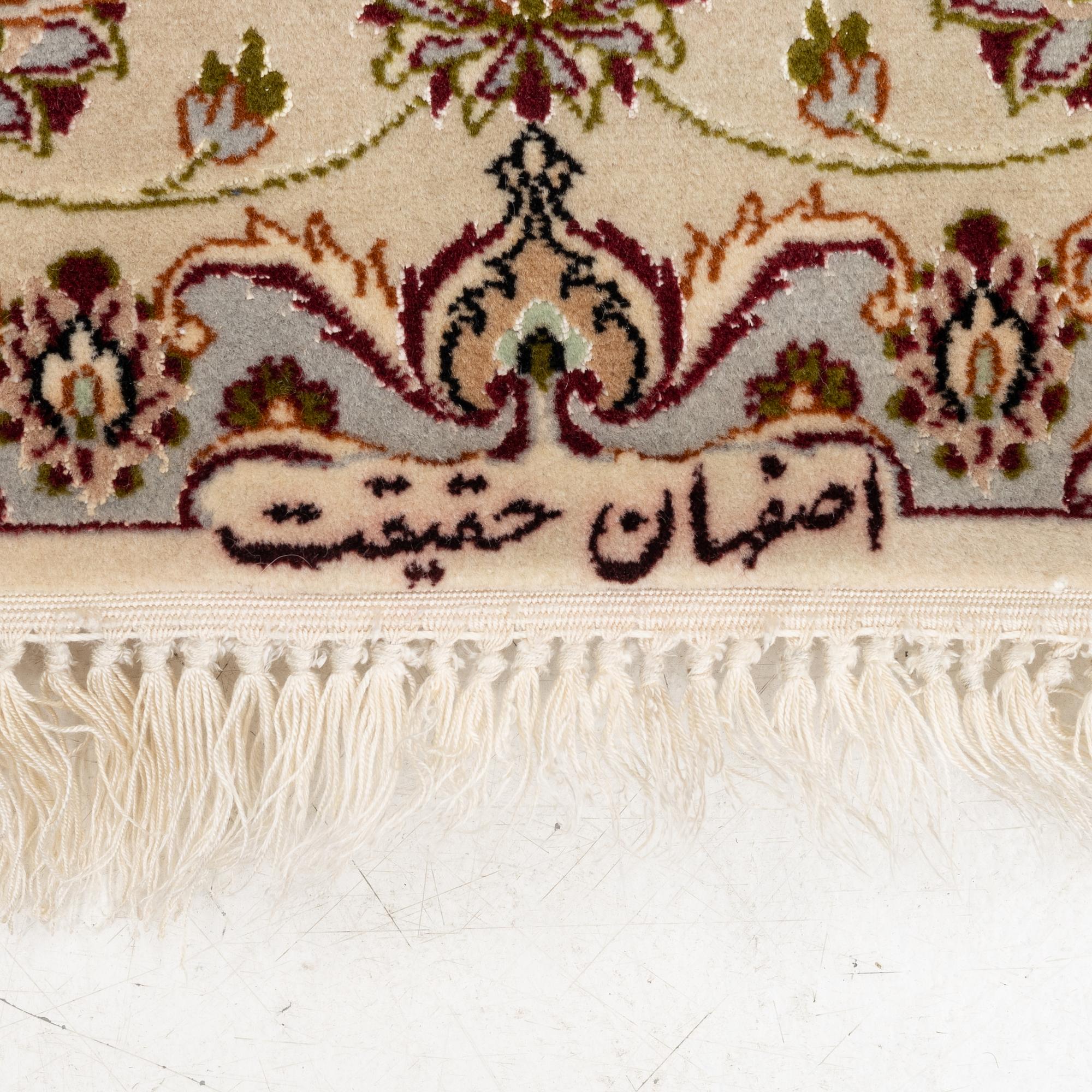 An Isfahan, part silk rug, signed, c. 165 x 112 cm.