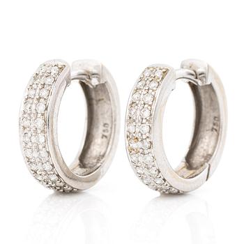 A pair of 18K white gold earrings with round brilliant-cut diamonds.