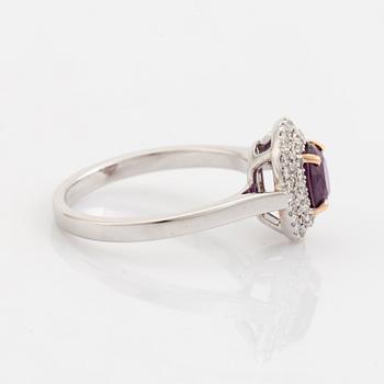 An 18K white gold ring set with a faceted ruby.