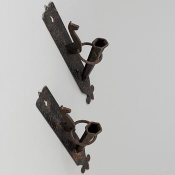 A pair of 20th century wrought iron torch holders.