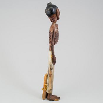 A wooden sculpture of a indian man, early 20th Century.
