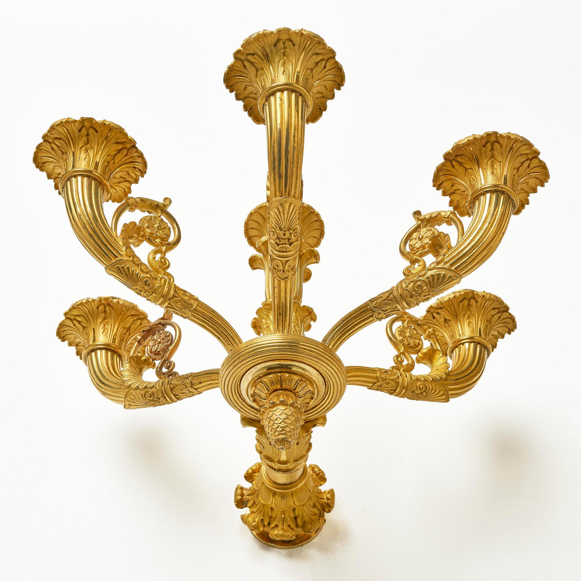 A pair of French Empire six-branch ormolu appliques, ca 1820's.