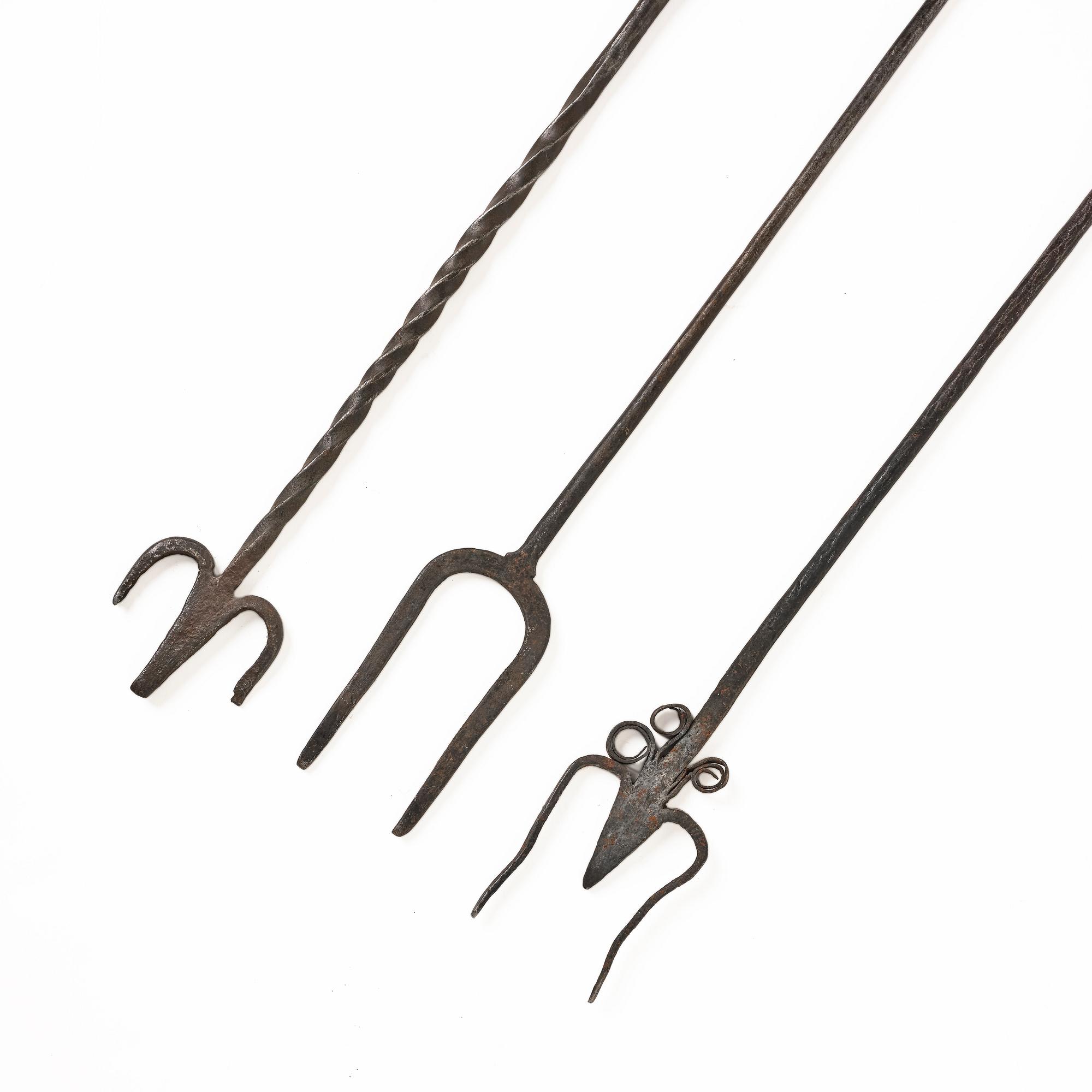 A set of three wrought iron fireplace pokers, 18th / 19th century.
