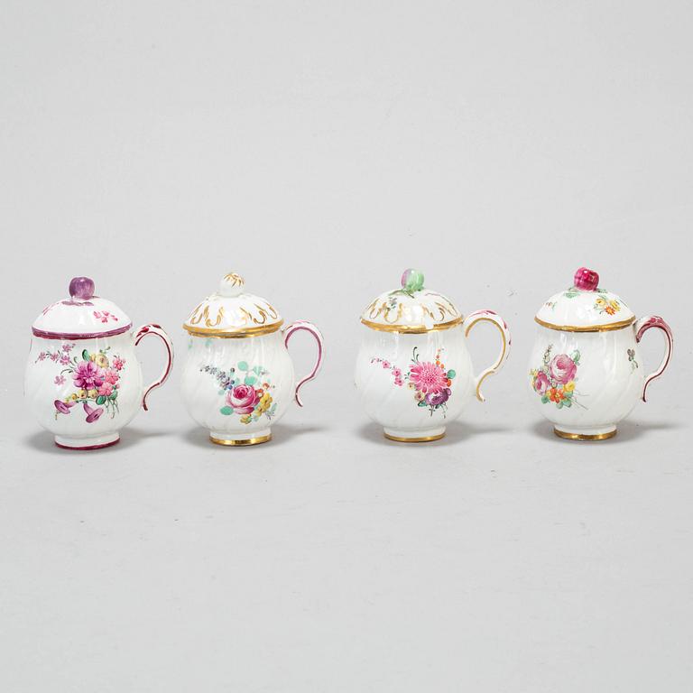 A set of four odd soft paste custard cups with covers, 18th Century.