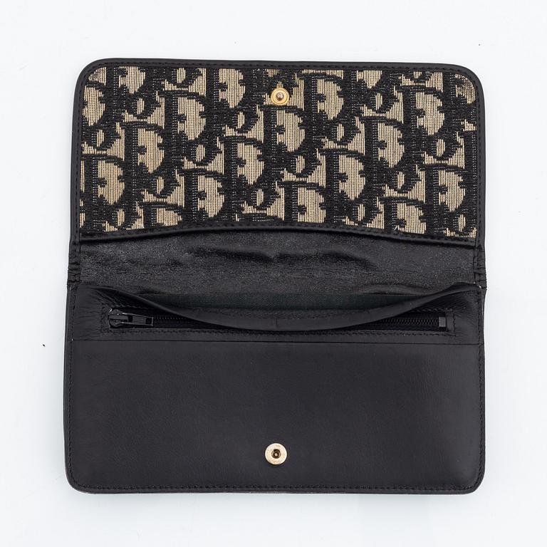 Christian Dior, a black canvas umbrella, toilet bag, coin purse and wallet.