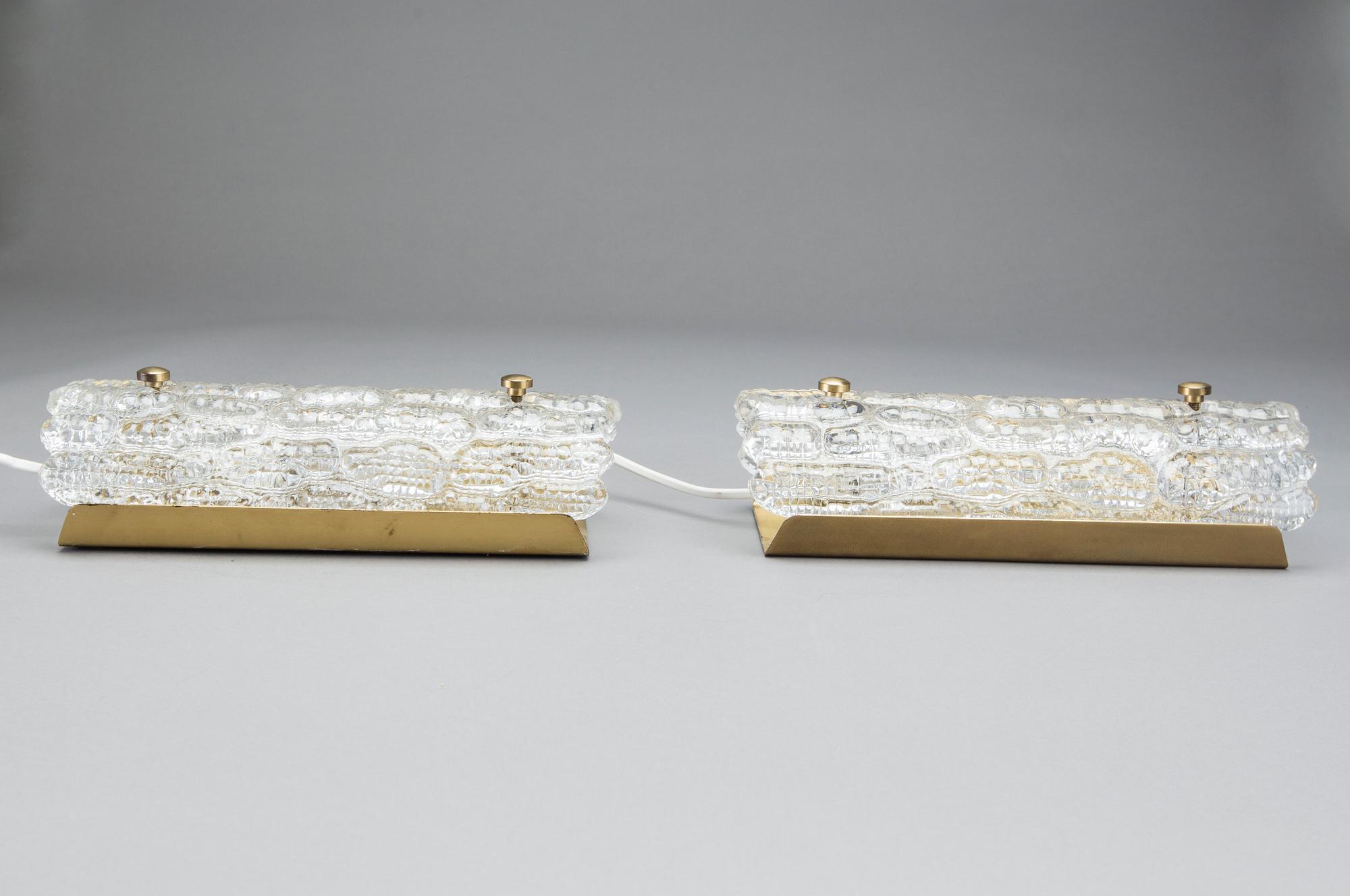 CARL FAGERLUND, a pair of glass and brass Orrefors wall lamps.