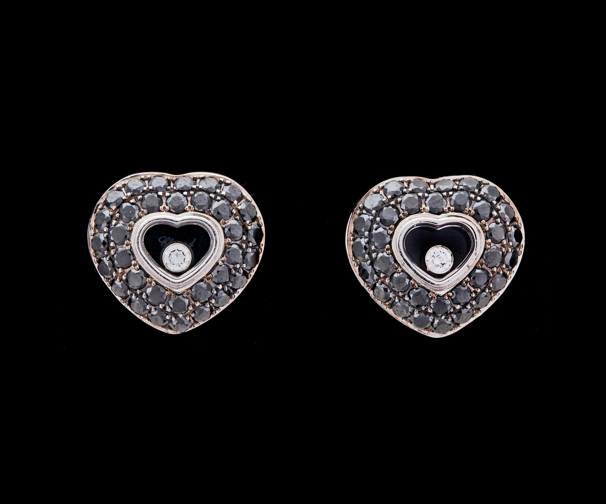 A pair of black and white Chopard 'happy diamond' heart earrings.