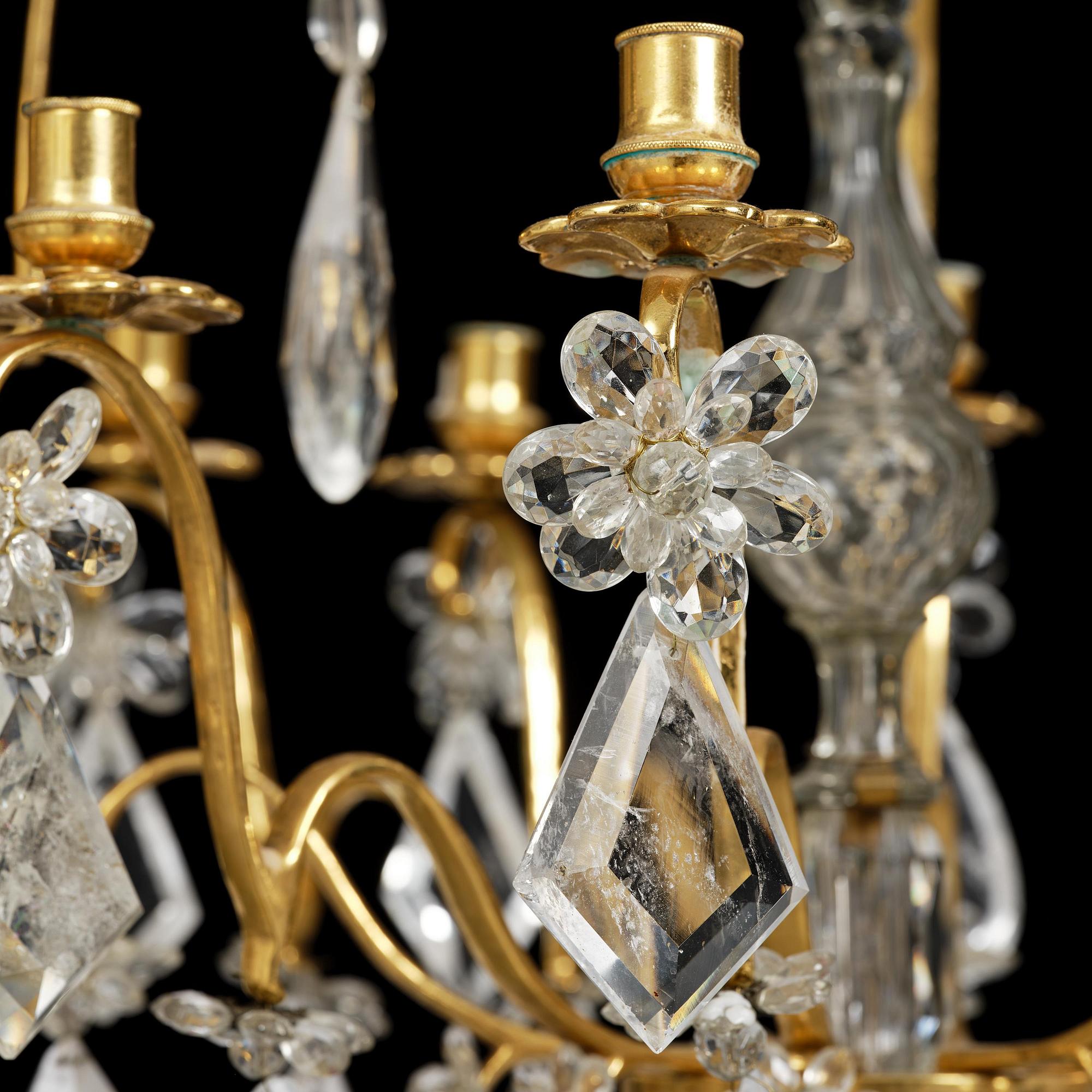 A near pair of Franch Louis-XV-style nine-branch gilt bronze and rock crystal chandeliers, later part 19th century.