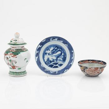 A Chinese dinner plate and a Japanese imari bowl, 18th Century together with a Chinese 19th Century jar with cover.