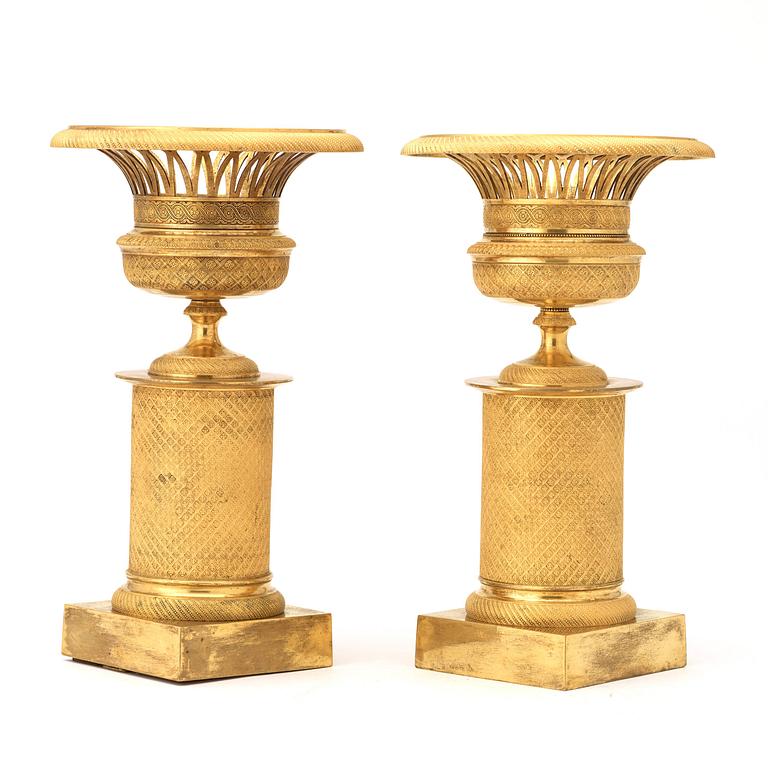 A pair of French Empire early 19th century gilt bronze urns.