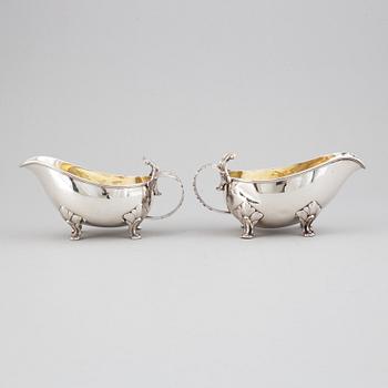 A pair of rococo-style parcel-gilt silver sauce-boats, mark of CGH, Stockholm 1945-1947.