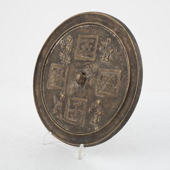 A bronze mirror, China, late Qing dynasty.