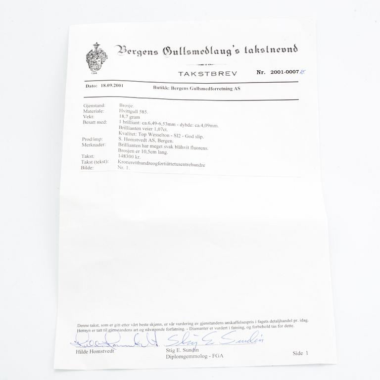 A 14K gold brooch set with a round brilliant-cut diamond.