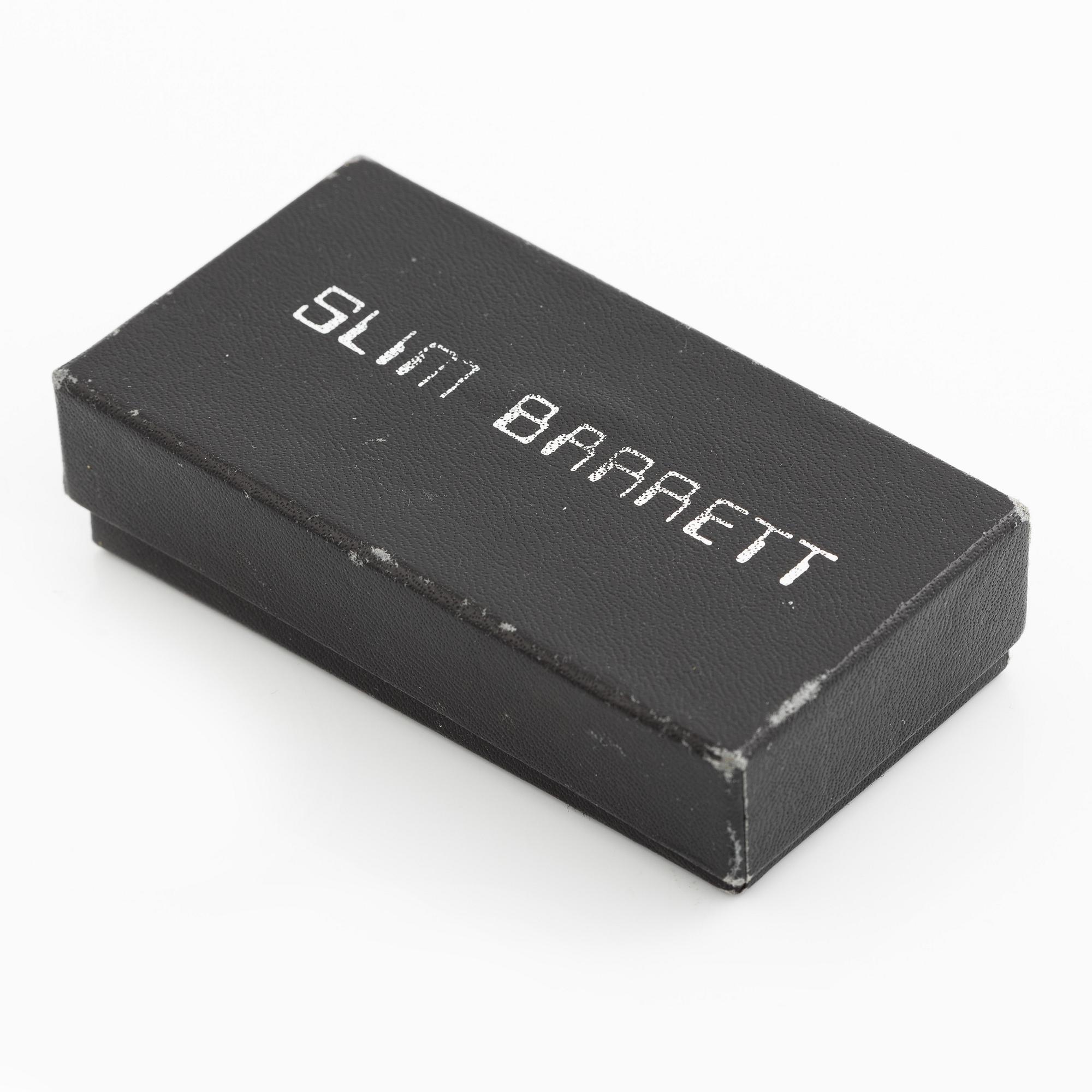 Earrings, possibly Slim Barrett.