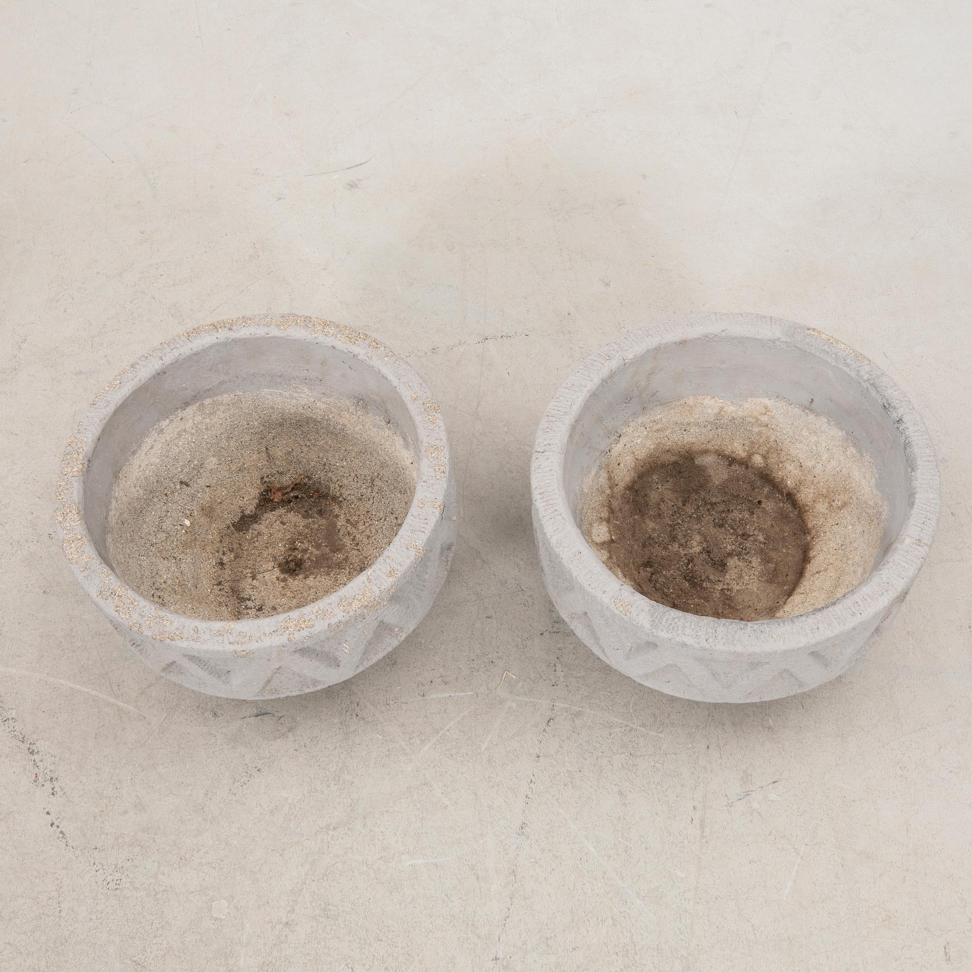A pair of concrete garden urns later part of the 20th century.