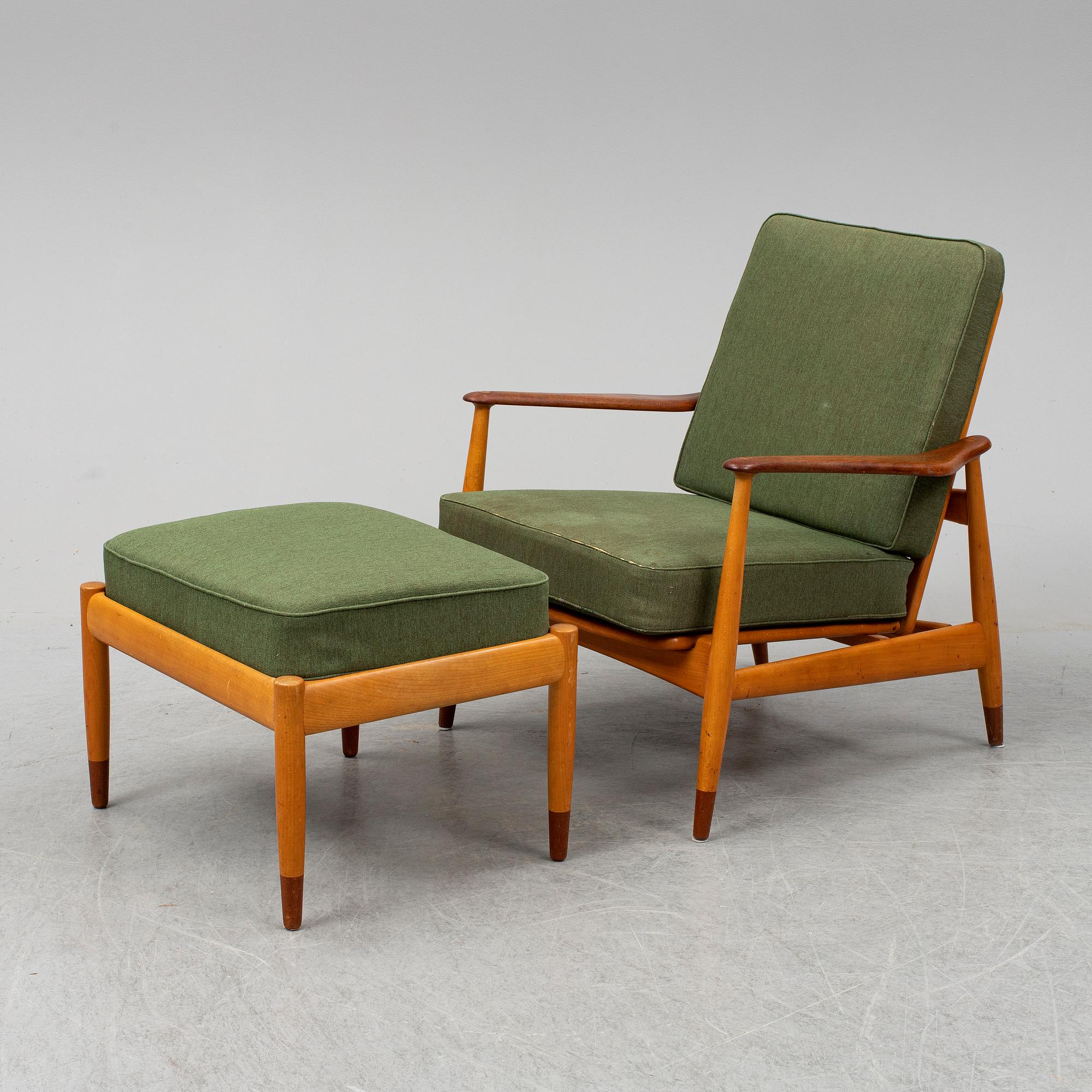 A 1950's beech and teak model FD 161 easy chair with stool by Arne Vodder for France & Son.