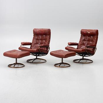 A pair of swivel armchairs with ottomans, 1970's.