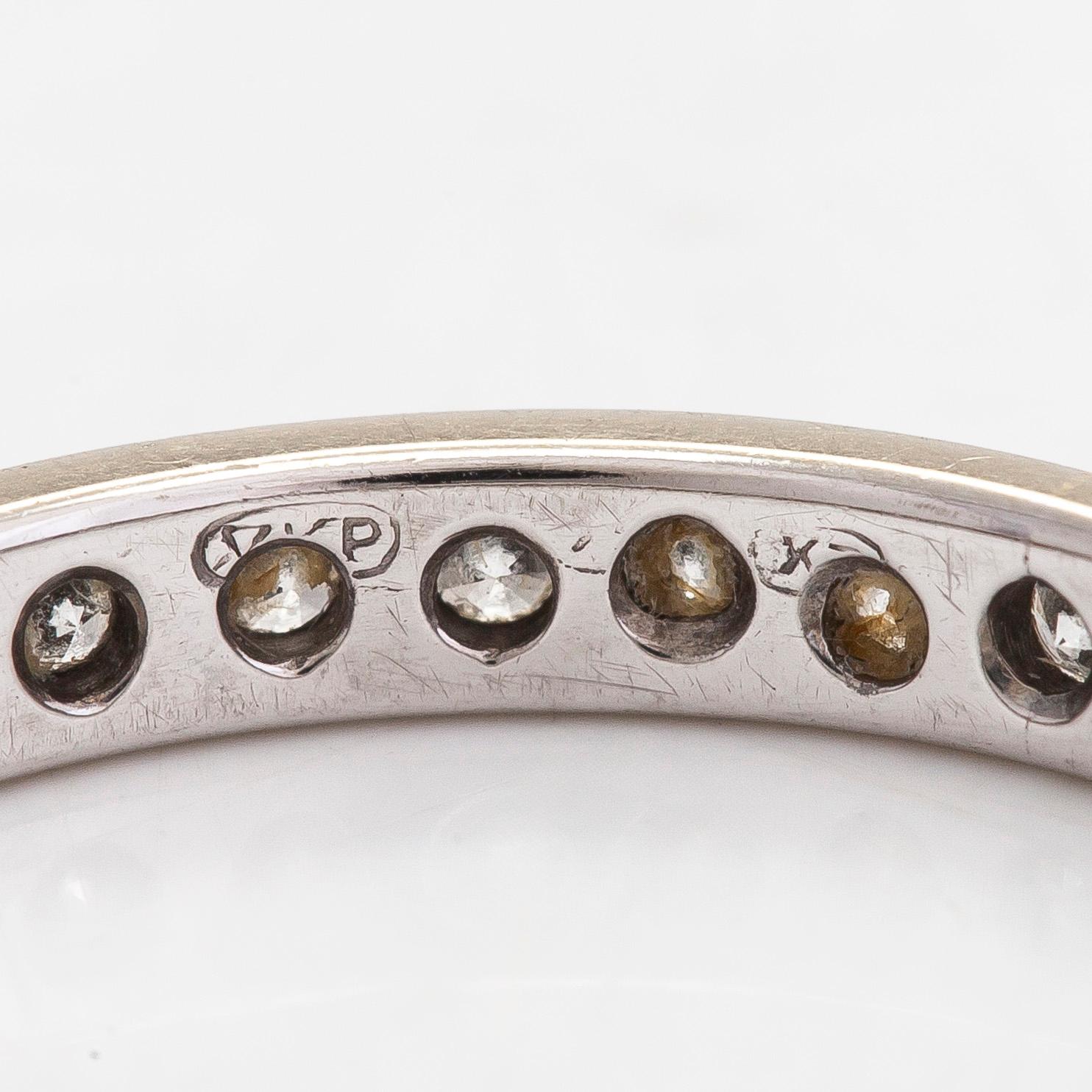 An 18K white gold eternity ring with brilliant-cut diamonds totalling approximately 0.60 ct.