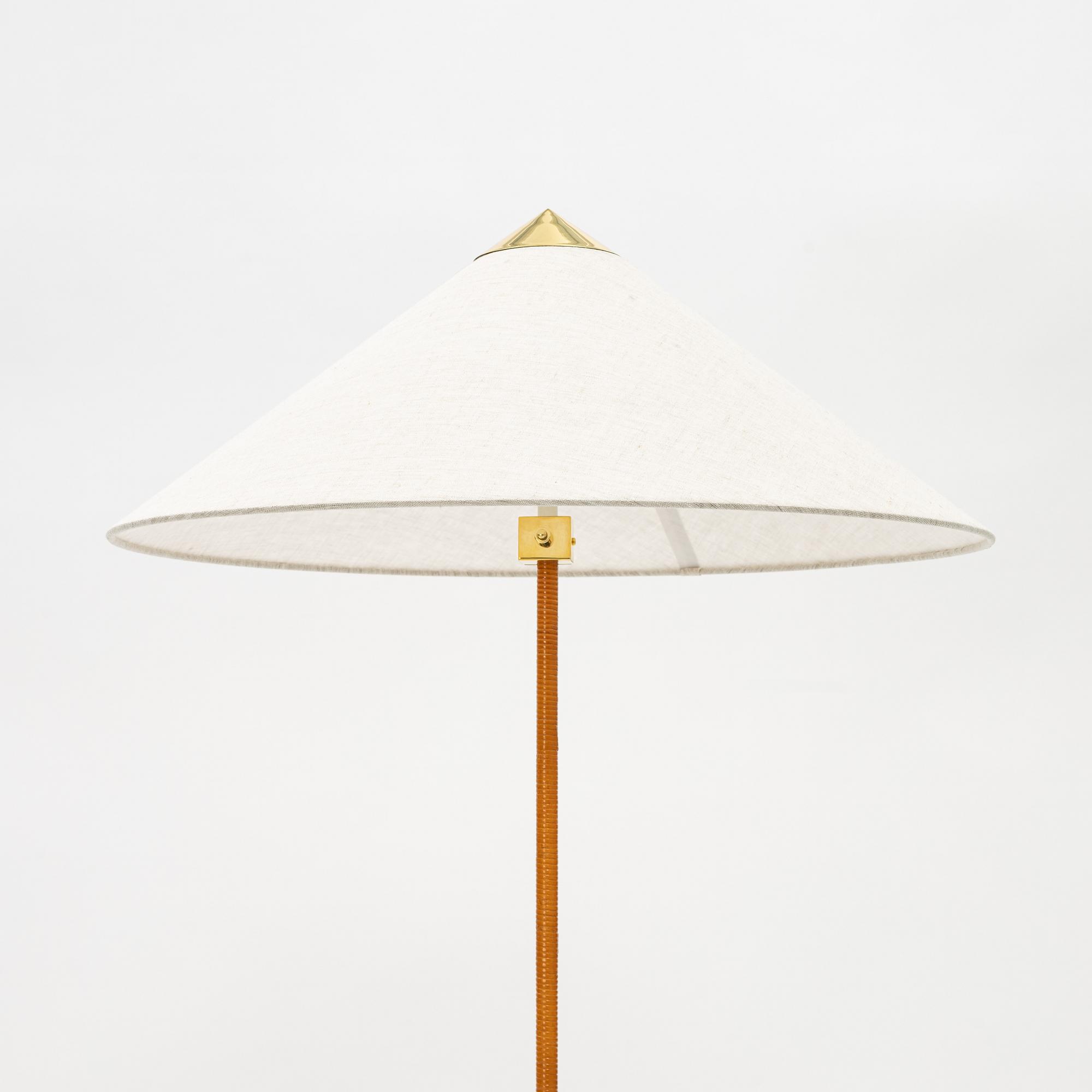 Paavo Tynell, A model 9602 brass and rattan floor lamp with canvas shade from Gubi,