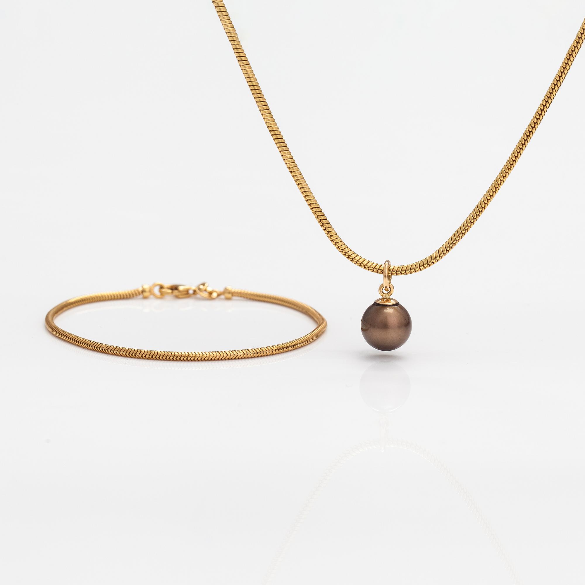 A 14K gold necklace and bracelet with a cultured pearl.