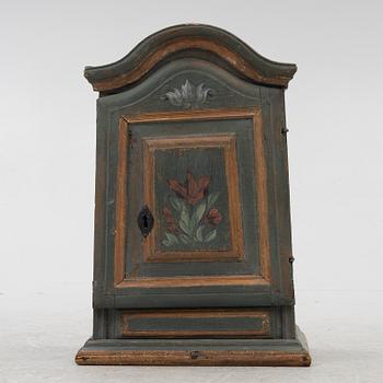 A painted wall cabinet, 19th century.