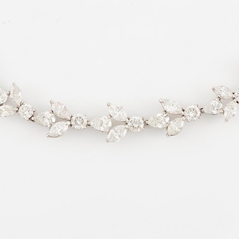 A platinum necklace set with navette-, pear- and round-brilliant-cut diamonds.