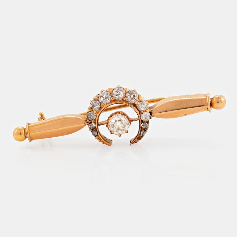 An 18K gold brooch set with old- and rose-cut diamonds.