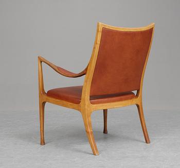 A Hans Asplund walnut and leather easy chair, exclusively made for the beauty parlour at Nordiska Kompaniet, 1955.