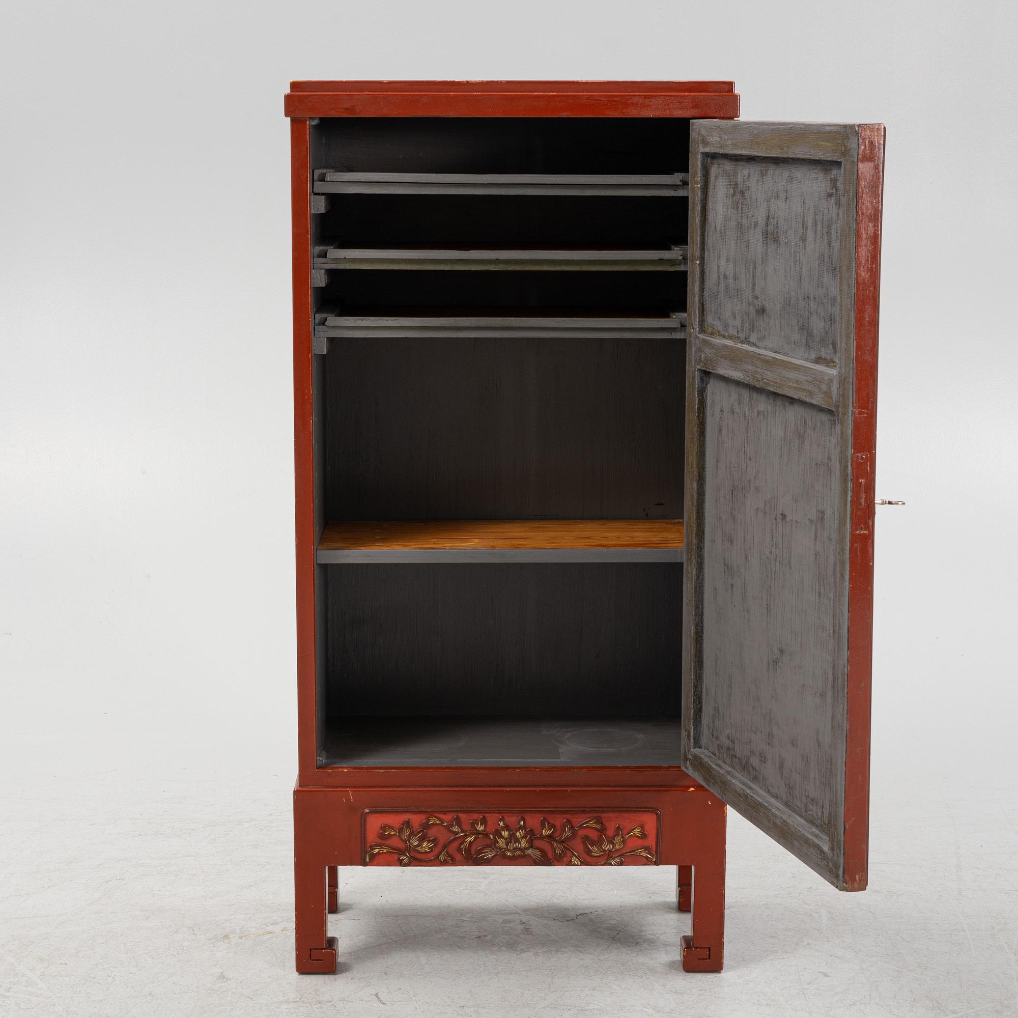 A Chinese cabinet, early 20th Century, with 19th Century carved panels.