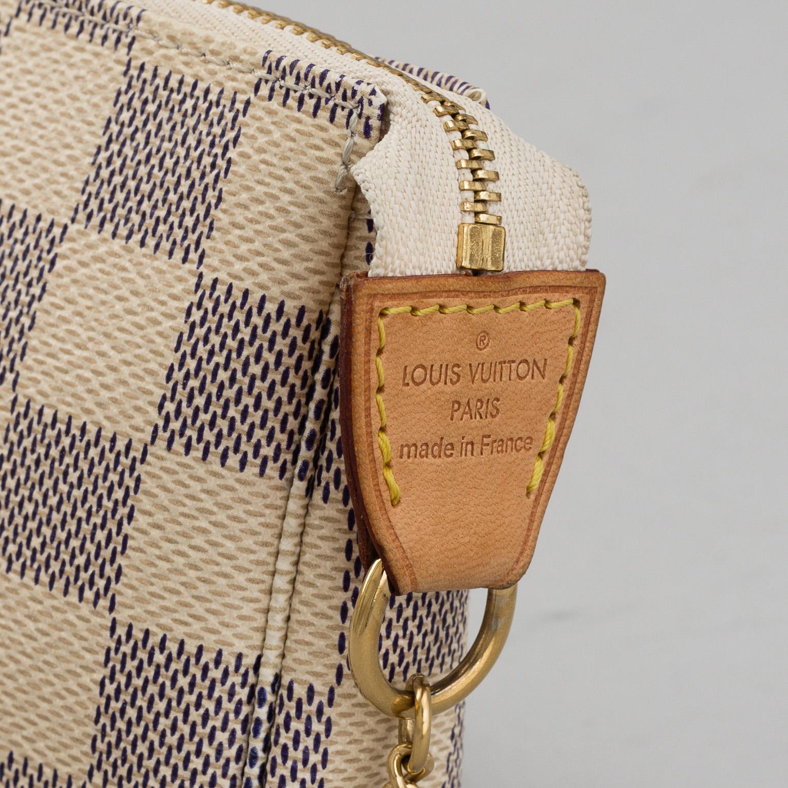 LOUIS VUITTON, A 'Mini Pochette Accessoires' and a shoulder strap.