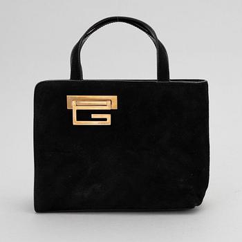 Gucci, a black suede handbag.