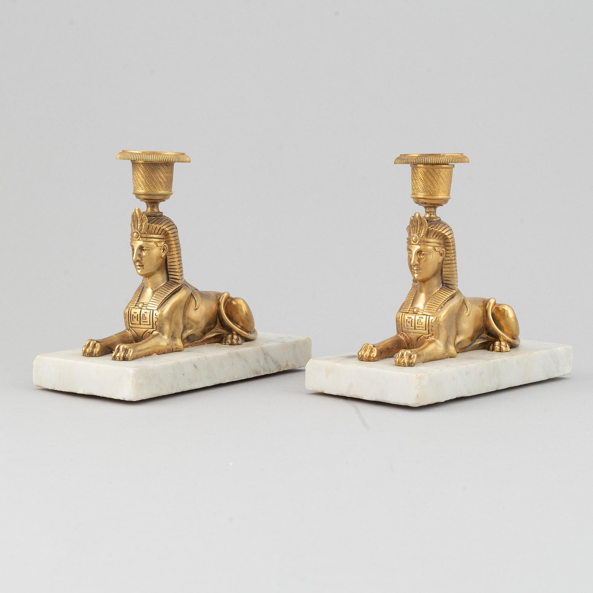 A pair of empire style 19th century candlesticks.