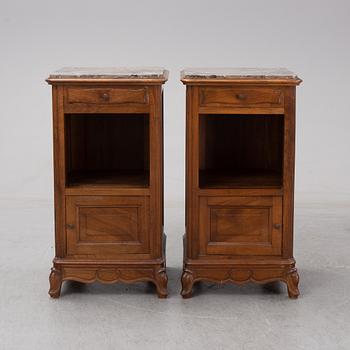 A pair of walnut marble top bedside tables, first half of the 20th Century.