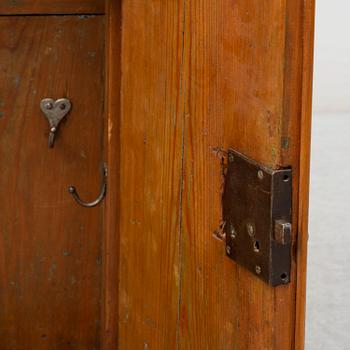 A first half of the 18th century late baroque elm veneered wall cabinet.