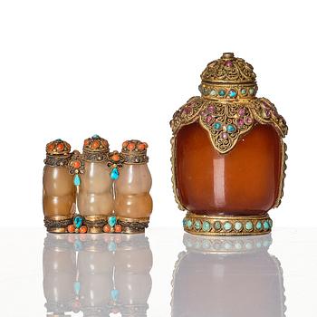 A set of four Chinese snuff bottles and a sculpture, 20th Century.