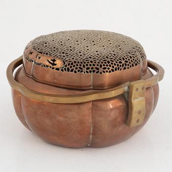 A Chinese copper handwarmer, late Qing dynasty.