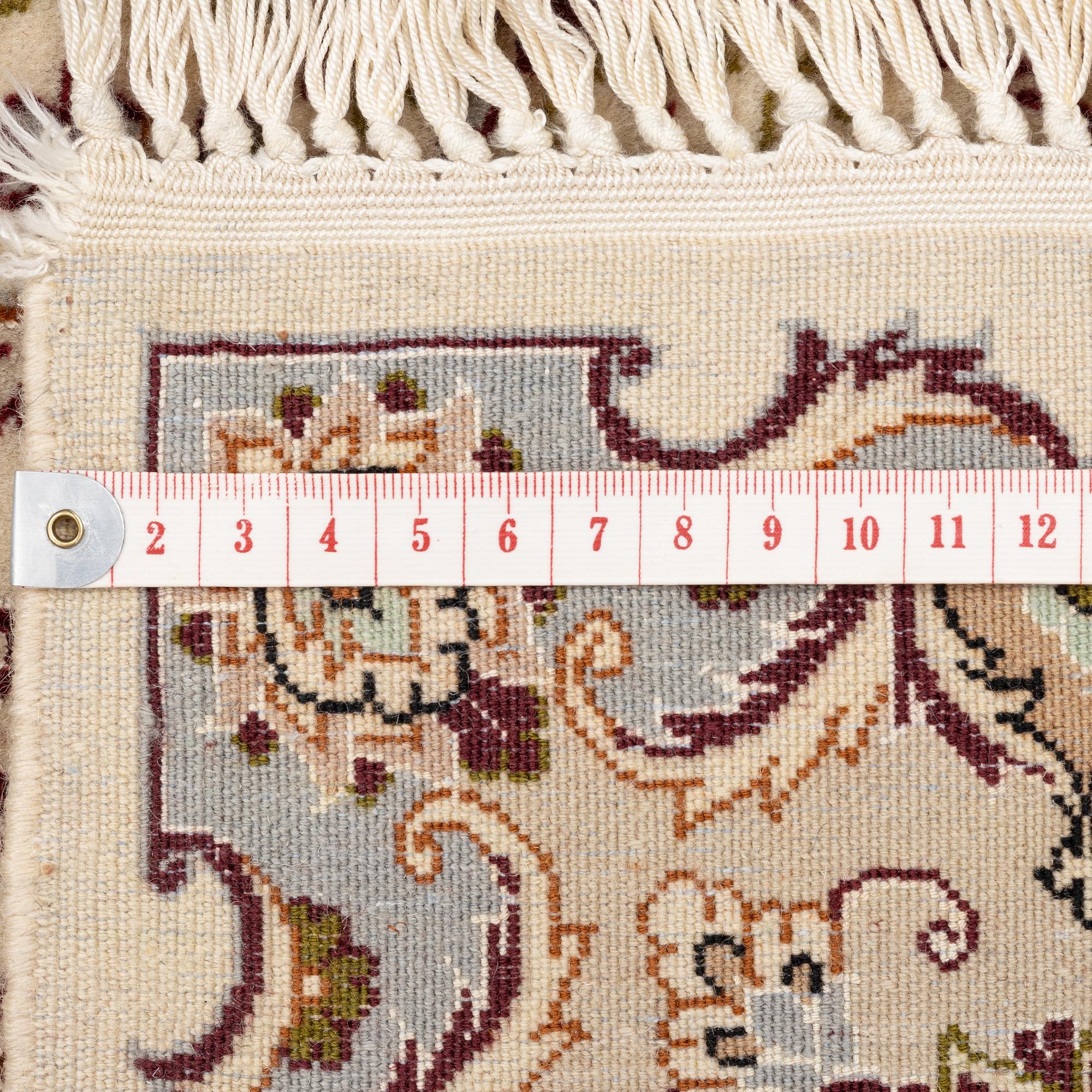 An Isfahan, part silk rug, signed, c. 165 x 112 cm.