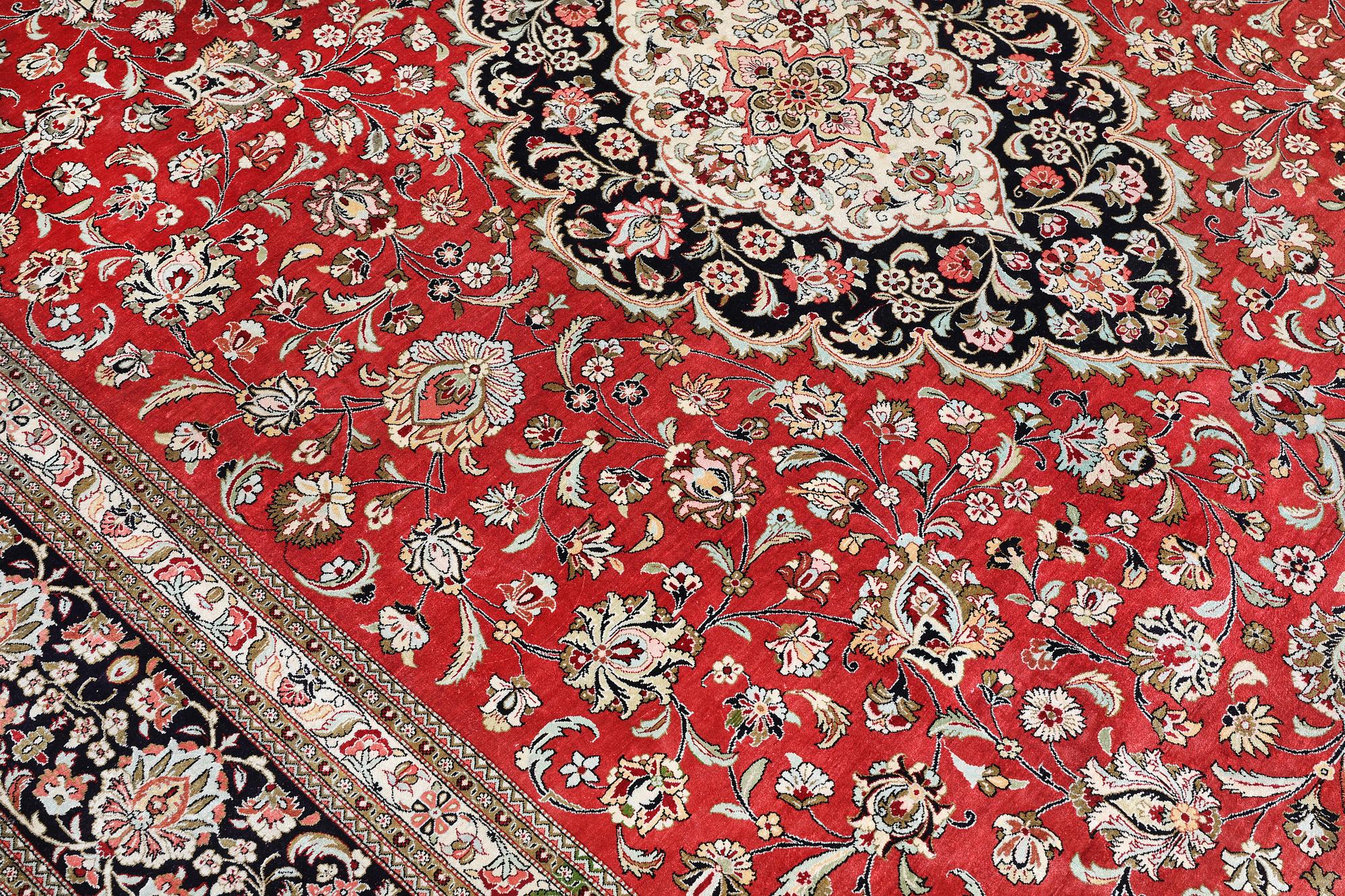 A silk Ghom carpet, c. 346 x 247 cm.