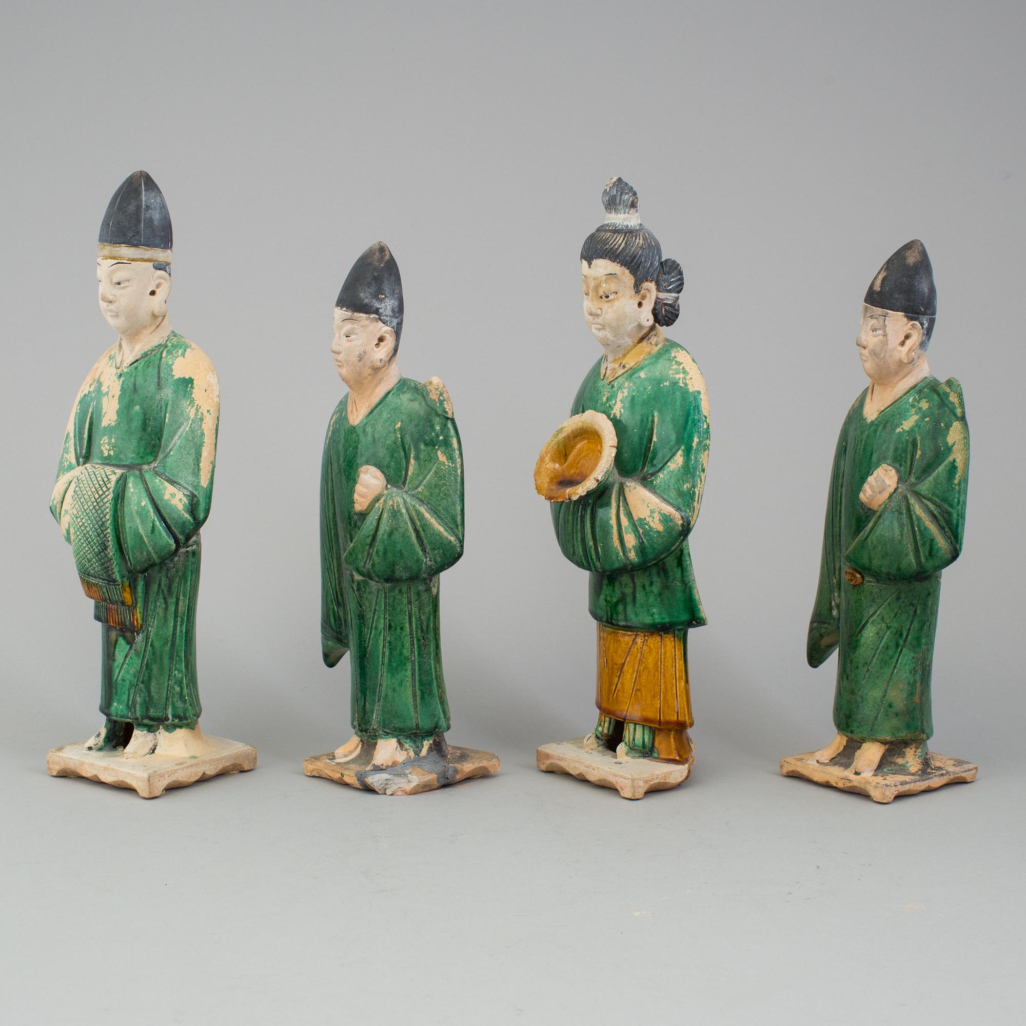 A group of eight chinese figures with three objects, earthenware, Ming dynasty.