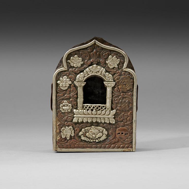 A gau amulet box with repousse worked front, Tibet, 19th Century.