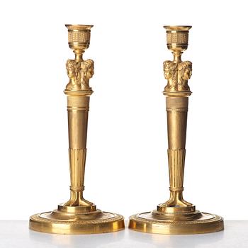 A pair of French Empire early 19th century gilt bronze candlesticks.