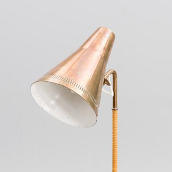 A brass floor lamp, marked Idman.