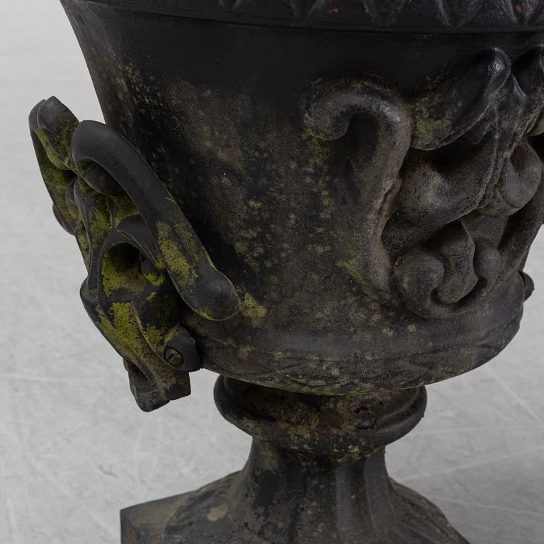 A pair of cast iron garden urns, Norrtälje dated 1989.